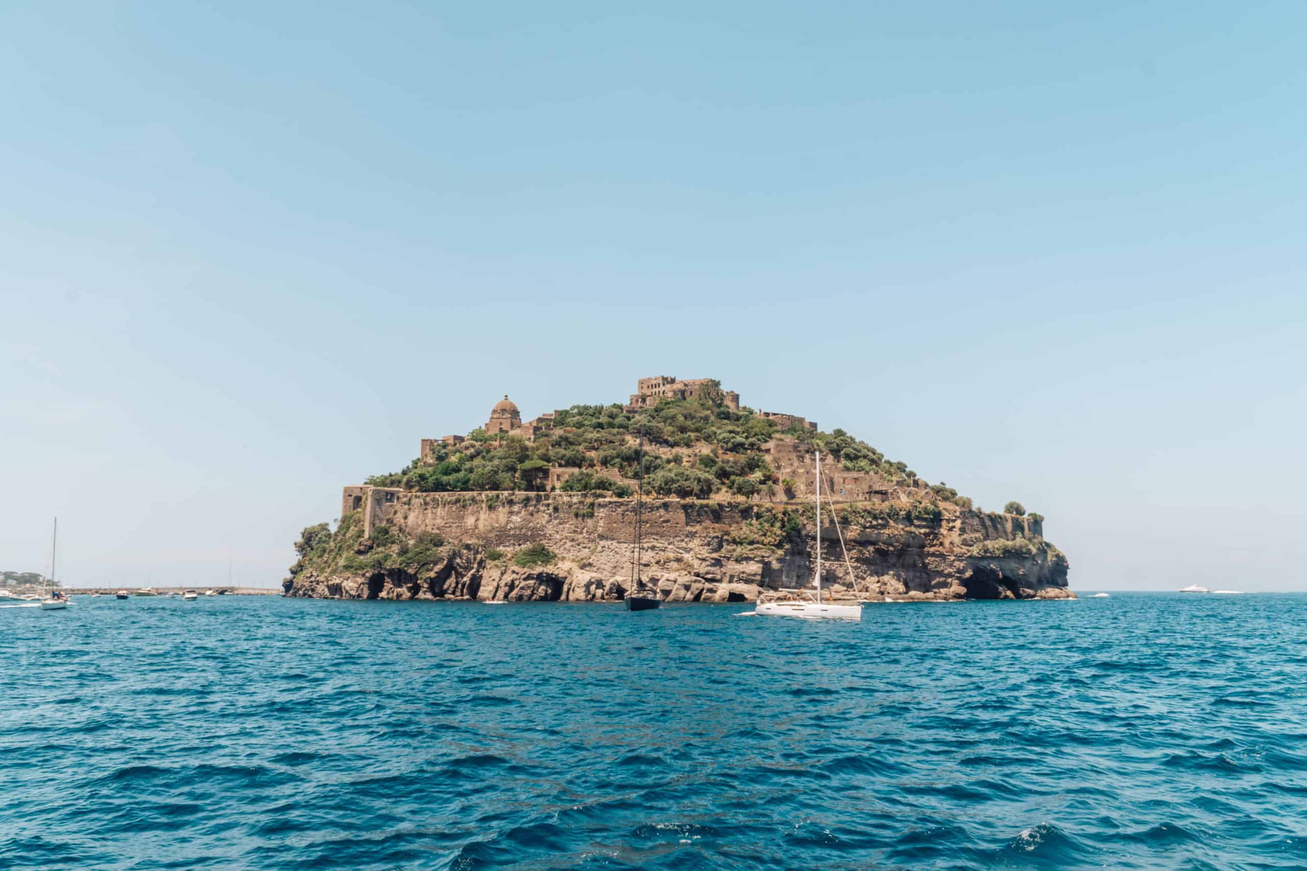 View of Castello Aragonese from Giardino Eden beach club on Ischia island in Italy