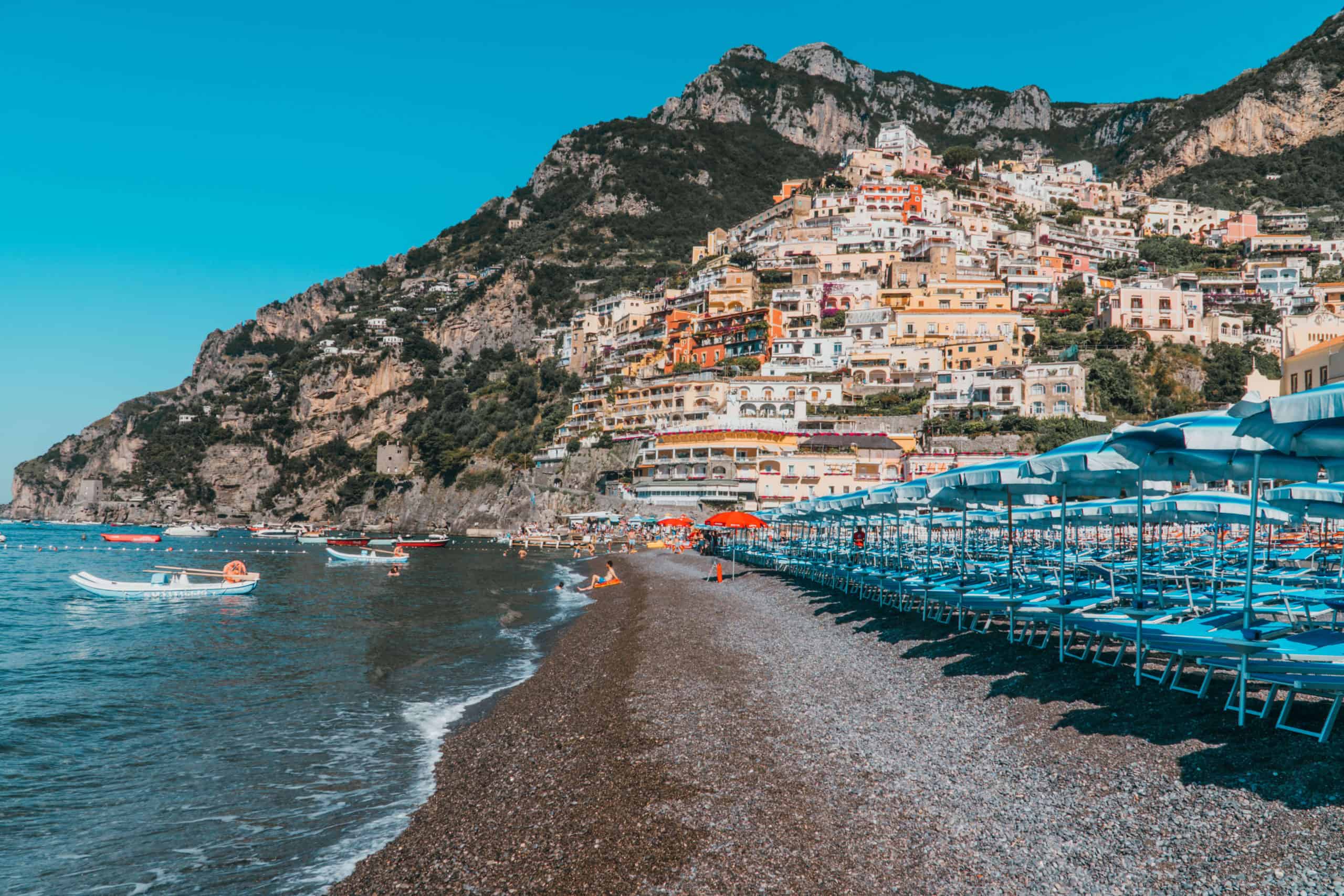 Colorful beach chairs and umbrellas on the beach in Positano, Italy