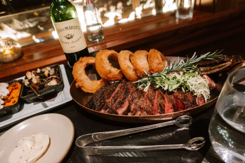 Steak and onion rings at Westbank Grill at the Four Seasons Jackson Hole