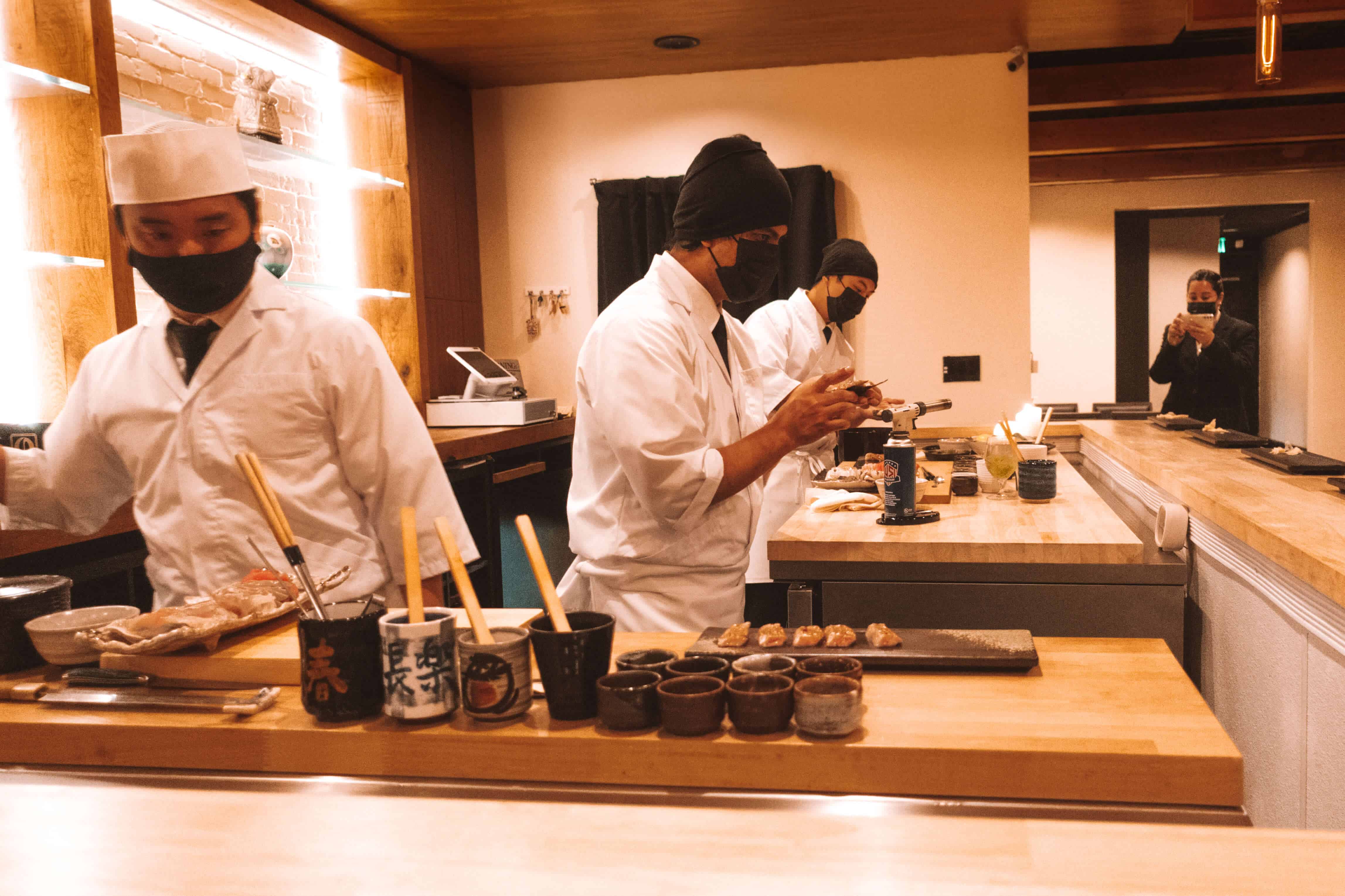 Sushi chef preparing fish at Rebel Omakase in Laguna Beach