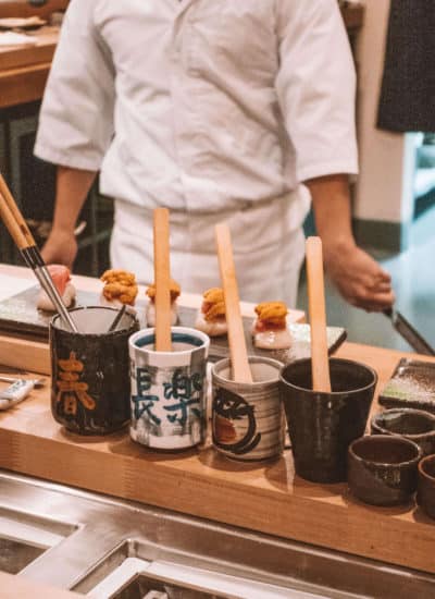 Sushi chef preparing uni hand rolls at Rebel Omakase in Laguna Beach