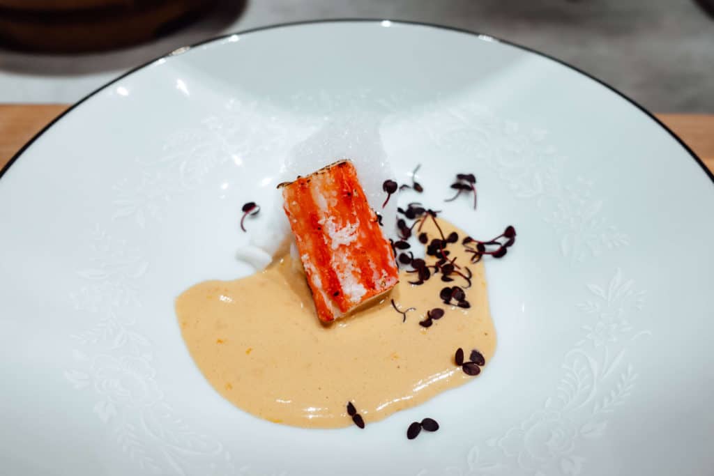 King Crab leg topped with garlic foam and sea urchin sauce in Omakase by Gino