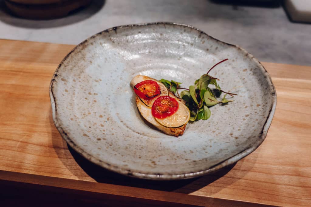 Black cod baked with thinly sliced tomato and lime at Omakase by Gino